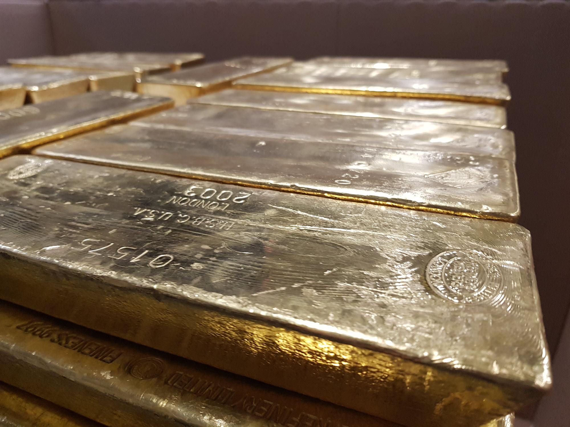 Close-up of gold bars stacked on a pallet